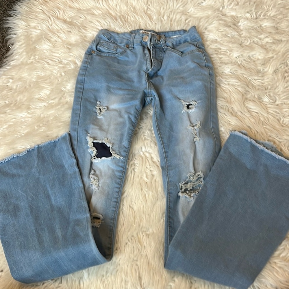 Light blue ripped flare jeans for juniors.